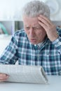 Close up portrait of senior man reading newspaper Royalty Free Stock Photo