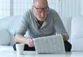 Senior man reading newspaper at home Royalty Free Stock Photo