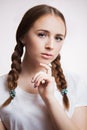 Close up portrait of sensual beautiful young girl on white background. Attractive woman with long eyelashes and clean skin, braids Royalty Free Stock Photo