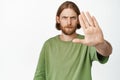 Close up portrait of serious bearded man extending hand, frowning upset tell to stop, prohibit or forbid smth, stay no