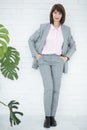 Close up portrait of a serious business woman in gray suit standing in the city Royalty Free Stock Photo