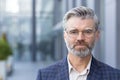 Close-up portrait of serious focused businessman, mature man wearing glasses and business suit looking at camera from Royalty Free Stock Photo