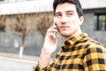 Close up portrait of a serious man with focused view speaking on the phone and looking away Royalty Free Stock Photo