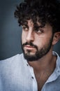 Close up portrait of a serious young man with a beard and curly hair Royalty Free Stock Photo