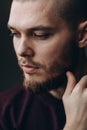 Close-up portrait of a serious young man looking away on a gray background. bald with a beard Royalty Free Stock Photo