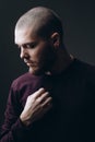 Close-up portrait of a serious young man looking away on a gray background. bald with a beard Royalty Free Stock Photo