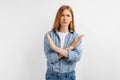 Serious young woman, arms crossed, showing stop gesture, on white background Royalty Free Stock Photo