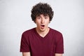 Close up portrait of shocked young man, expresses great surprisment. Astonished male, keeps mouth open, receives unexpected news, Royalty Free Stock Photo