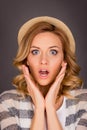 Close up portrait of shocked young woman touching her face Royalty Free Stock Photo