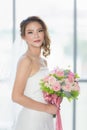 Asian bride standing and holding a bouquet Royalty Free Stock Photo