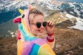 Portrait of female hiker in a unicorn costume in mountains