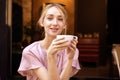 Close-up portrait shot of happy young woman drinking coffee at the cafe Royalty Free Stock Photo