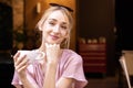 Close-up portrait shot of happy young woman drinking coffee at the cafe Royalty Free Stock Photo