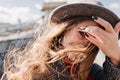 Close-up portrait of shy blue-eyed lady plays with dark long hair. Photo of spectacular white woman with black manicure Royalty Free Stock Photo