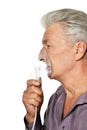 Portrait of sick senior man with inhaler isolated