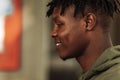 Close-up portrait from side of handsome african american man smiling and looking into the camera. cheerful, positive Royalty Free Stock Photo