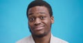 Close up portrait of silly black man with unsure facial expression, grimacing face and shaking head