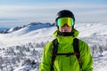 Close-up portrait of a skier or snowboarder in sports equipment, snowy mountains background at ski resort Royalty Free Stock Photo