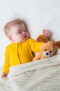 Close-up portrait of a sleeping baby in an embrace with a toy . Vertical photo Royalty Free Stock Photo