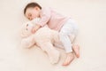 Close-up portrait of sleeping beautiful baby toddler girl with a fluffy teddy bear on the bed Royalty Free Stock Photo