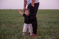 Close-up portrait of small boy looking curiously ahead while being held securely by parents hand Royalty Free Stock Photo