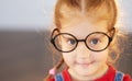 Close up portrait of smart little child girl in glasses