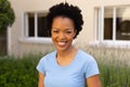 Close-up portrait of smiling african american young woman smiling while standing outdoors Royalty Free Stock Photo