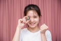 close up Portrait of a smiling Asian woman wear white shirt and holding Golden Ethereum ETH with Cryptocurrency hand picked and