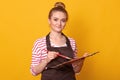 Close up portrait of smiling blonde artist girl with palette of colour in art studio, attractive young female wearing striped