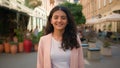 Close up portrait smiling calm young Indian Arabian ethnic woman female girl student businesswoman standing city street Royalty Free Stock Photo