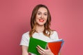 Close up portrait of smiling caucasian female student isolated on pink background in studio Royalty Free Stock Photo