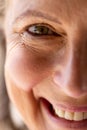 Close-up portrait of smiling caucasian senior woman with brown eye looking at camera Royalty Free Stock Photo