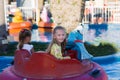 Close-up portrait of a smiling girl near the carousel at the fair. Happy child having fun in the amusement park. happy childhood Royalty Free Stock Photo