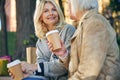 Cheerful two adult women relaxing while drinking coffee Royalty Free Stock Photo