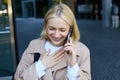 Close up portrait of smiling, laughing young woman, talking on mobile phone, standing outdoors, walking on street with Royalty Free Stock Photo