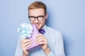 Close-up Portrait Of Smiling Man Holding Colorful Gift With Ribbon. Present, Birthday, Valentine