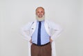 Close-up portrait of smiling mature bearded doctor with hands on