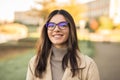 Close up portrait smiling newly admitted student multiethnic female wearing glasses in front of university