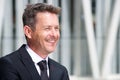 Close up portrait of smiling older businessman in suit and tie