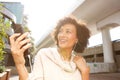 Close up smiling older woman listening to music with headphones and smart phone Royalty Free Stock Photo