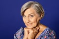 Close up portrait of smiling senior woman posing in studio Royalty Free Stock Photo