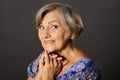 Portrait of smiling senior woman posing in studio Royalty Free Stock Photo