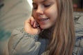 Close-up portrait of smiling teenage girl with braces, touching her hair against blurred background. Selective focus. Royalty Free Stock Photo