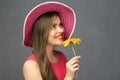 Close up portrait of smiling woman wearing red hat holding flower Royalty Free Stock Photo