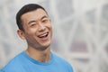 Close- Up portrait of smiling young athletic man in a blue t-shirt outdoors in Beijing, China Royalty Free Stock Photo