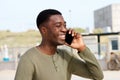 Close up of smiling young black man talking on cellphone outdoors Royalty Free Stock Photo