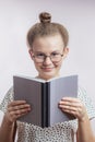 Close up portrait of smiling young female holding a book Royalty Free Stock Photo
