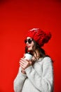 Close up portrait of a smiling young girl in hat holding take away coffee cup Royalty Free Stock Photo