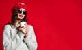 Close up portrait of a smiling young girl in hat holding take away coffee cup Royalty Free Stock Photo