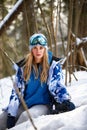Close up portrait of snowboarder woman at ski resort wearing helmet and goggles with reflection of forest in mountains Royalty Free Stock Photo